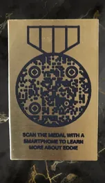 Brass plaque for a headstone with a medal-shaped QR code