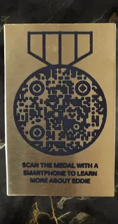 Veterans memorial plaque with a medal-shaped QR code