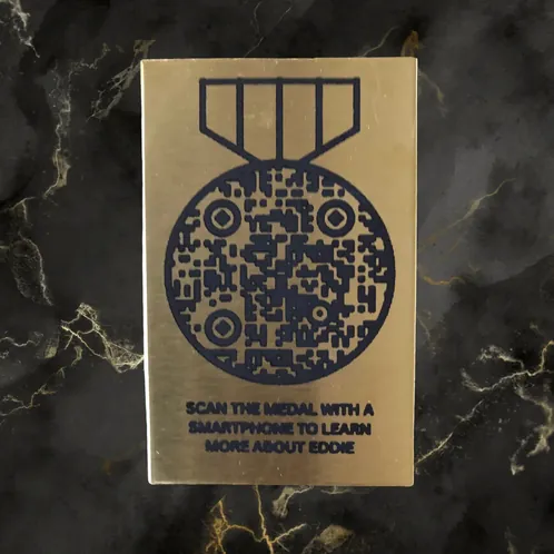 Brass plaque with a medal-shaped QR code